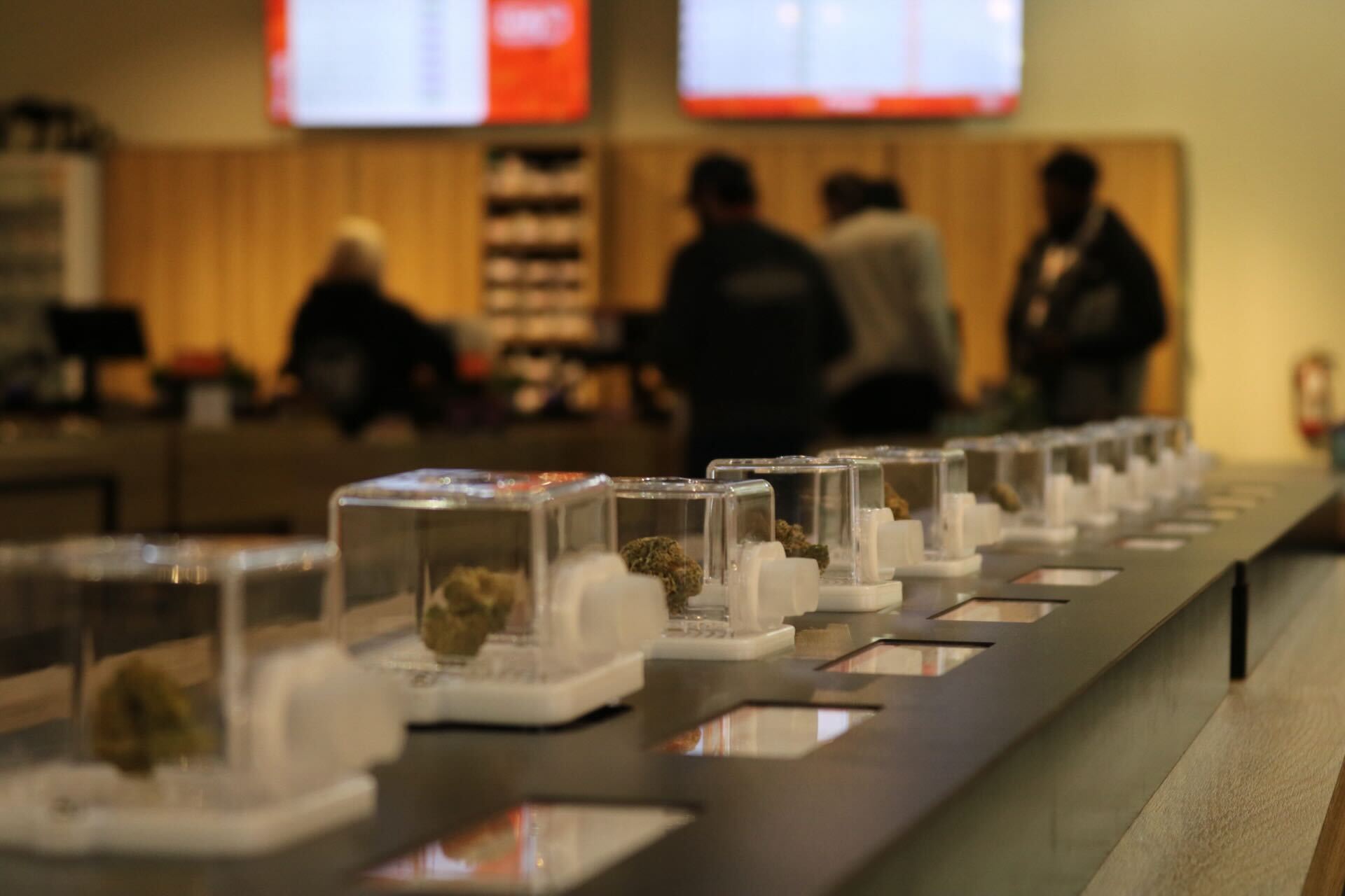 Unity Rd dispensary interior — premium flower display cases along the counter